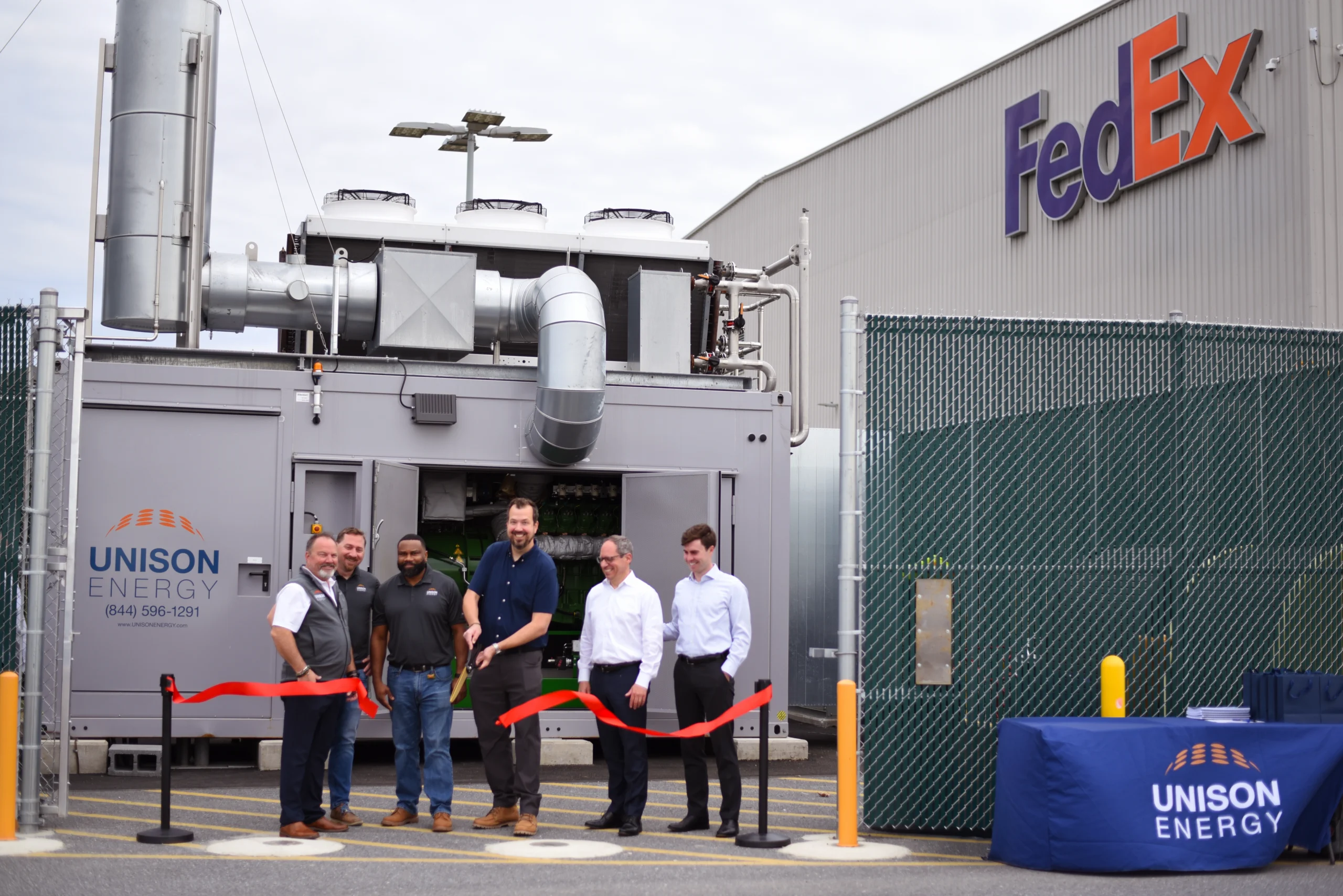 unison team ribbon cutting in fedex building