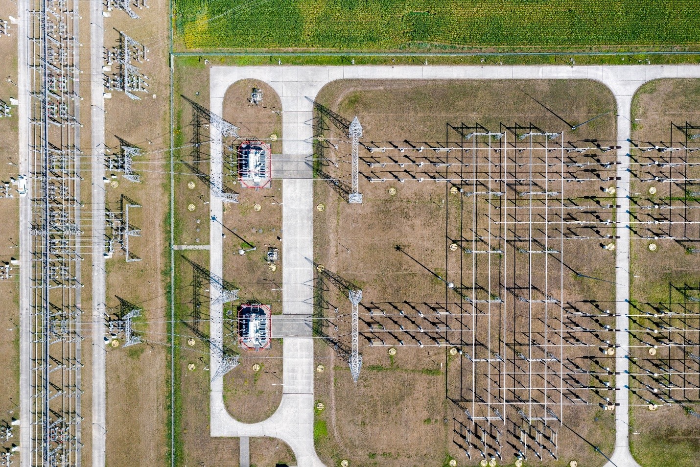 High-voltage electrical transmission lines carrying utility power across the U.S. electric grid, representing aging grid infrastructure, electricity transmission, and rising utility investment.